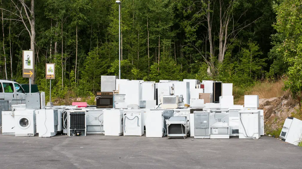 EZ-Haulin' team loading old appliances onto a truck for eco-friendly removal and disposal.