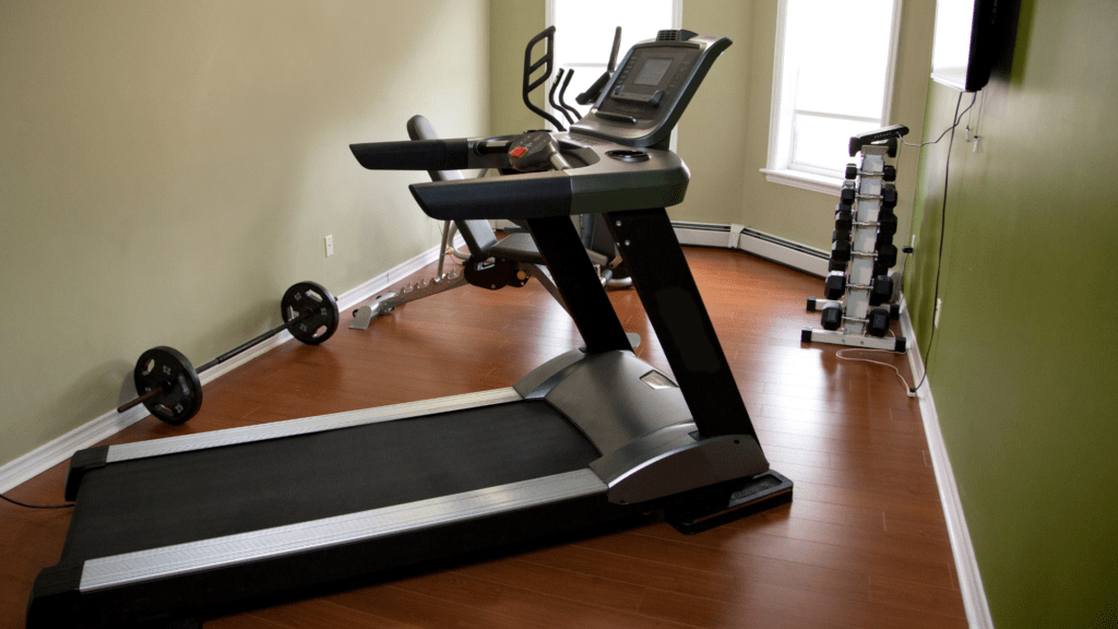 EZ-Haulin' team removing a bulky treadmill from a home and loading it onto a truck for eco-friendly disposal.