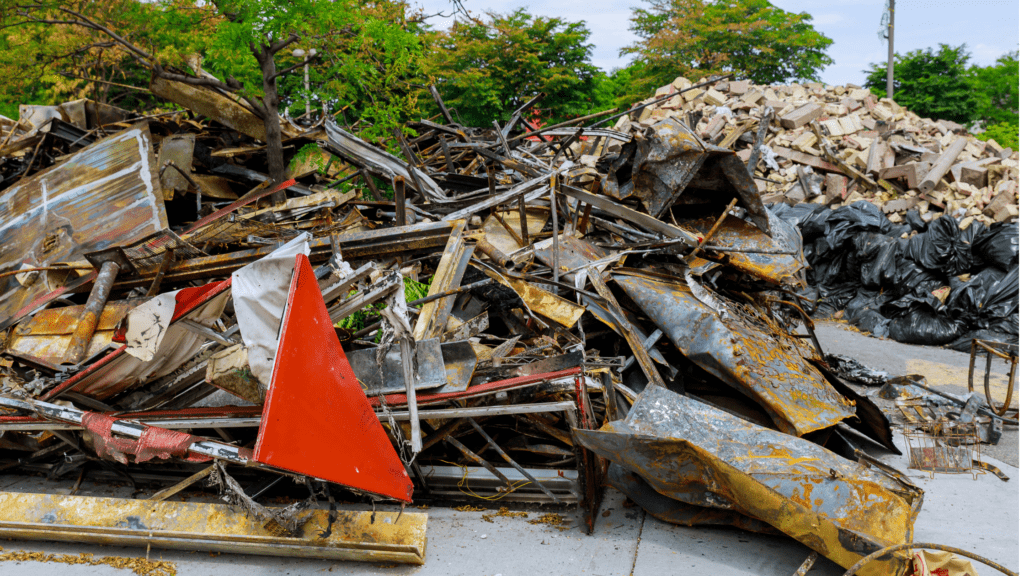 EZ-Haulin' team clearing and loading construction debris, including wood, drywall, and rubble, onto a truck for proper disposal.