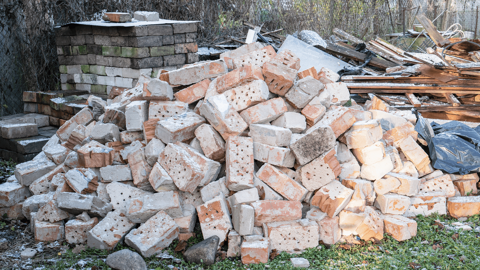 EZ-Haulin' team removing heavy brick and concrete debris from a construction site and loading it onto a truck for proper disposal.