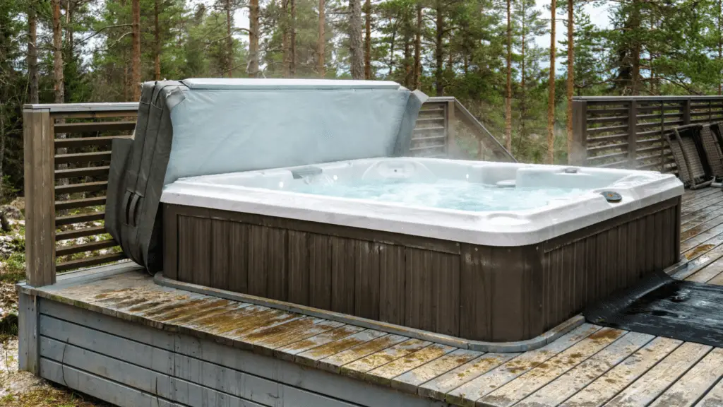 EZ-Haulin' team safely dismantling and loading a hot tub onto a truck for eco-friendly disposal or recycling.