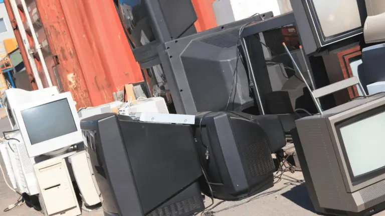EZ-Haulin' team safely removing and loading an old TV onto a truck for recycling or proper disposal.